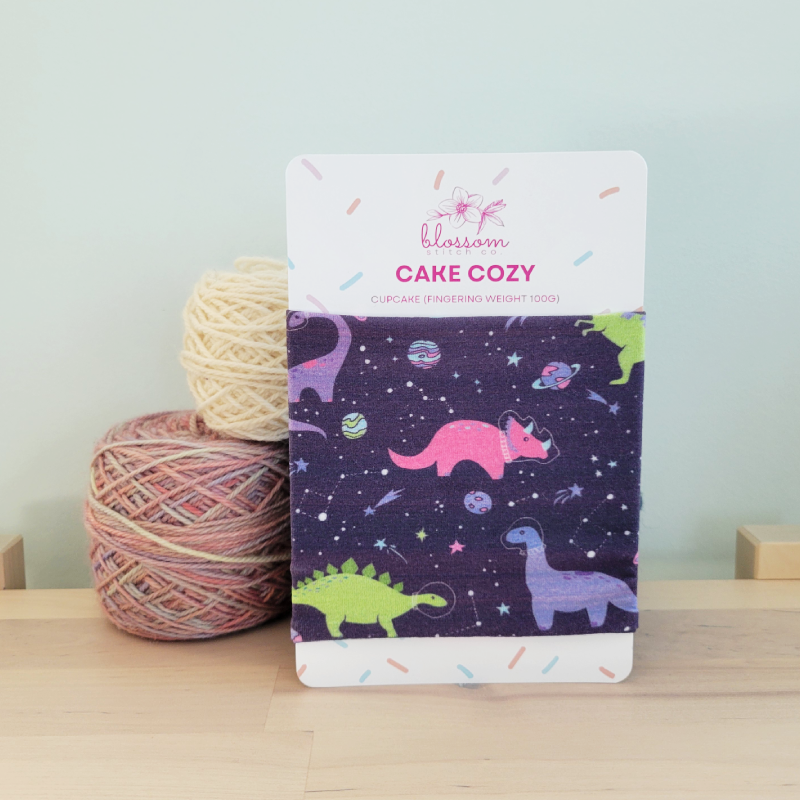 Blossom Stitch Co. Space Dinos Yarn Cake Cozy